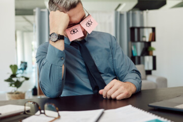 tired, sticky notes and businessman sleeping in his office with a burnout, exhaustion or overworked. overtime, rest and professional mature male lawyer taking nap on his lunch break in the workplace.